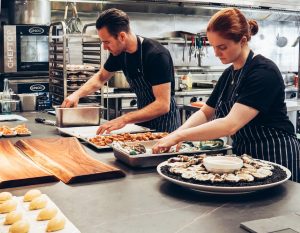 man-and-woman-wearing-black-and-white-striped-aprons-2696064